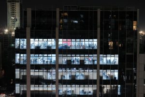 A night view of an office building in Central Visayas, Philippines, showcasing illuminated office windows.
